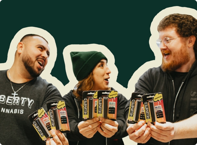 Liberty Cannabis staff members holding Hellavated vapes