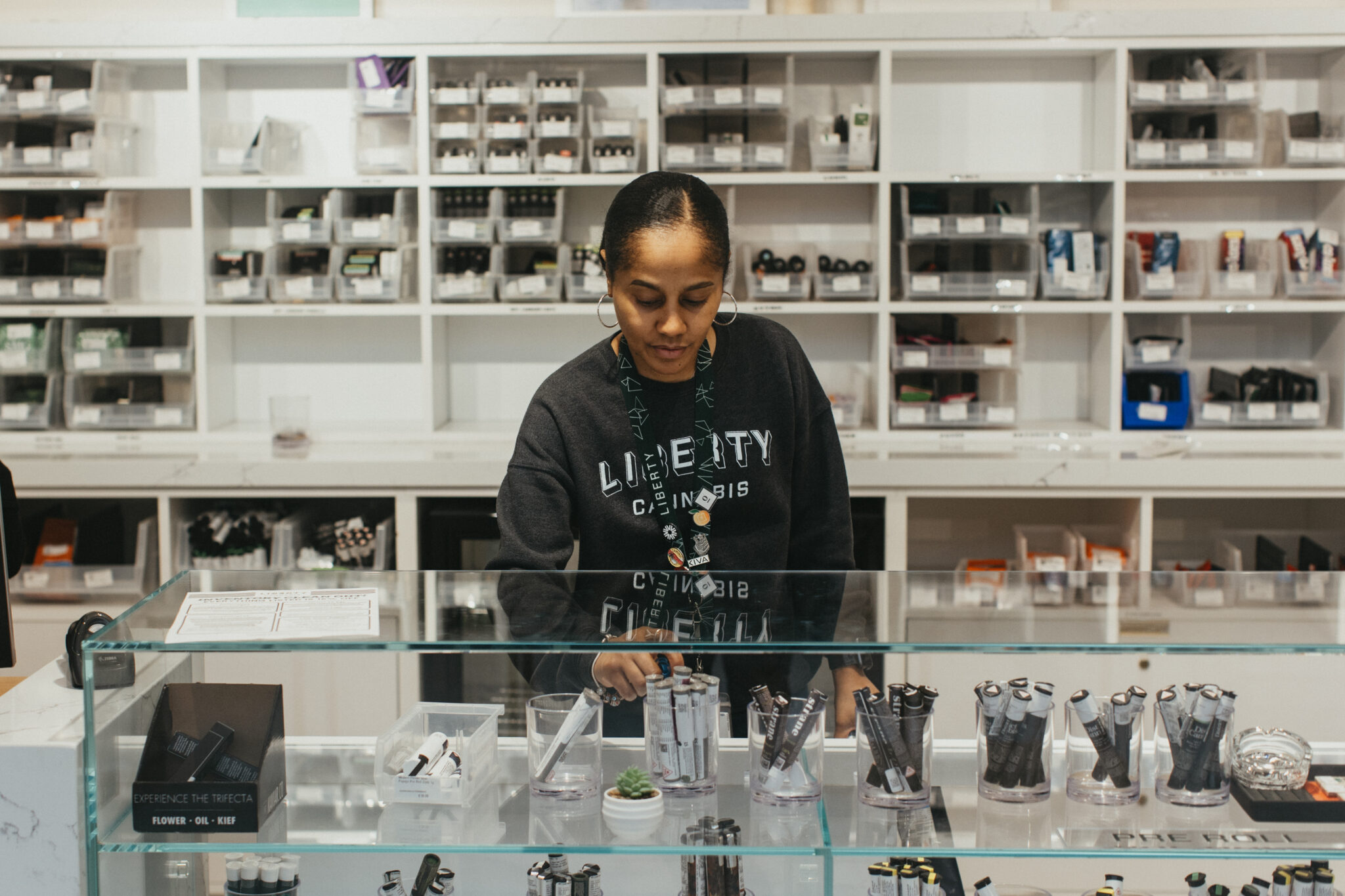 Liberty employee stocking shelves inside Oxon Hill Dispensary